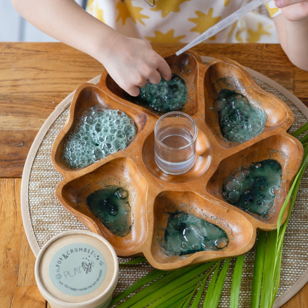 Child playing with Wild Mountain Child - PlayFizz Crumble - Cup in jewel hunt shown in w wooden flower tray