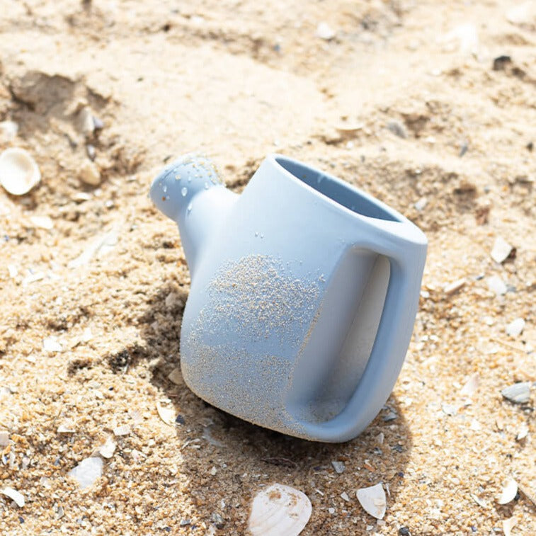 Cherub Baby - Bath & Beach Toys - Silicone Watering Can - Duck Egg sitting on the beach with sand