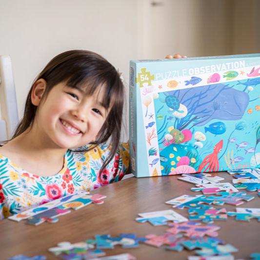 girl smiling with 
aquatic observation puzzle