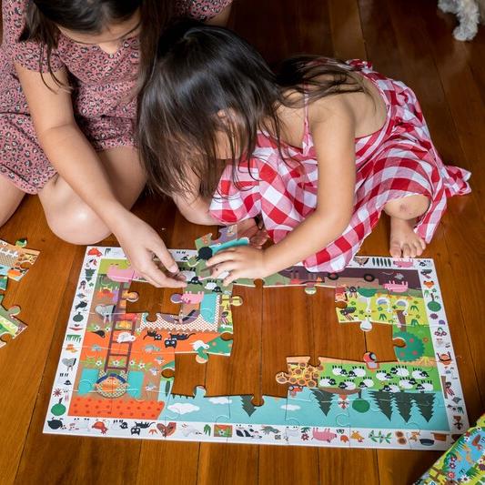 2 girls playing with farm theme puzzle