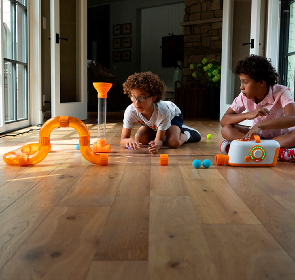 Children playing on floor with Fat Brain Toys Air Toobz Air-Powered STEM Building Toy