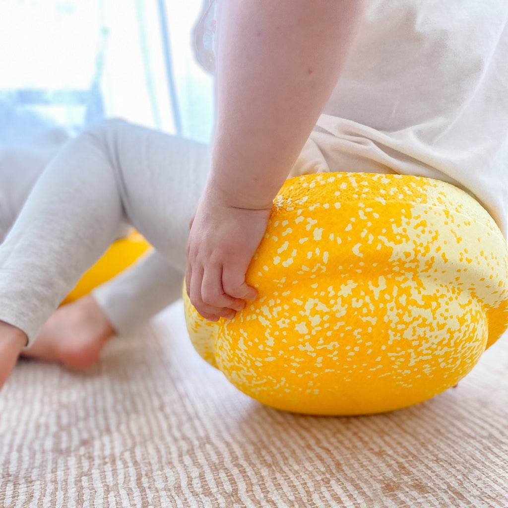 Child sitting on New limited edition Wattle Stapelstein for Australia 