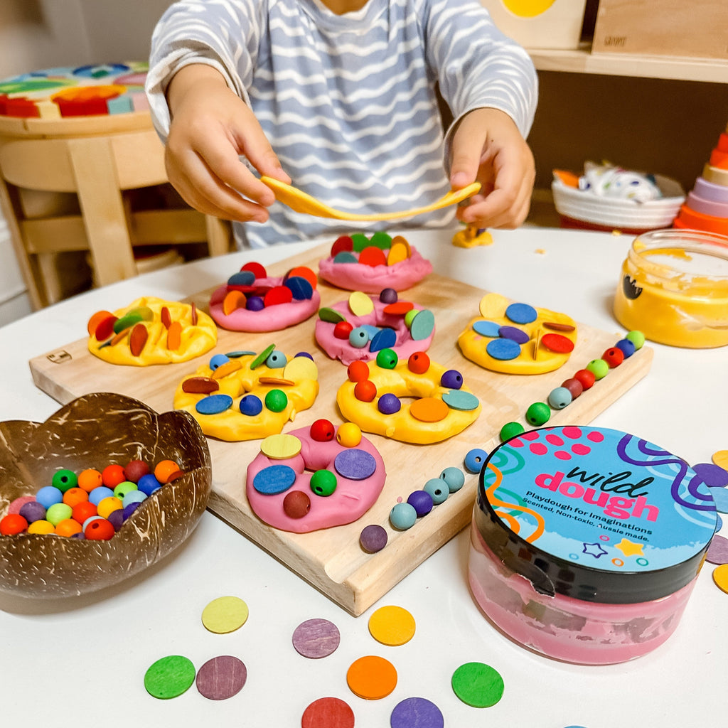 Playdough donuts made from Wild Dough and colourful beads and loose parts