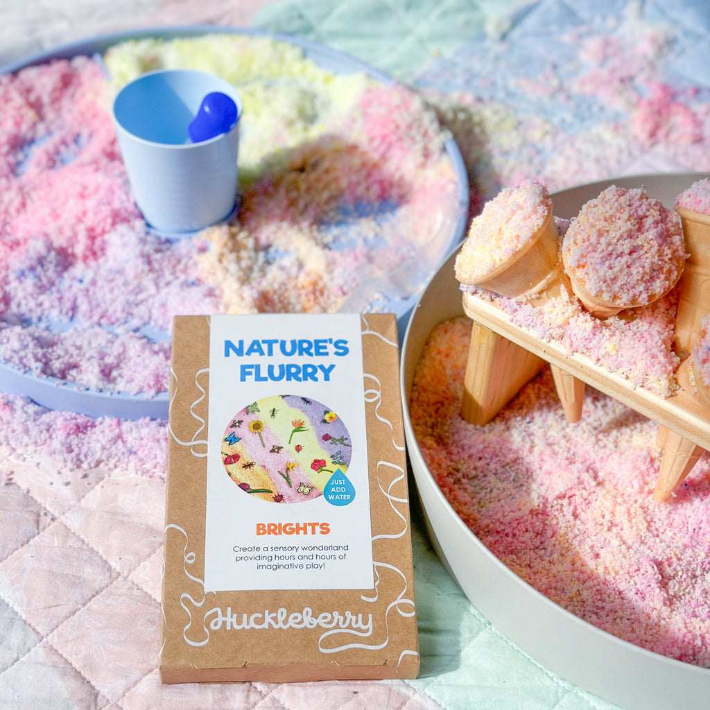 natures flurry making icecream cones in the jellystone play tray set up  on a colourful play quilt