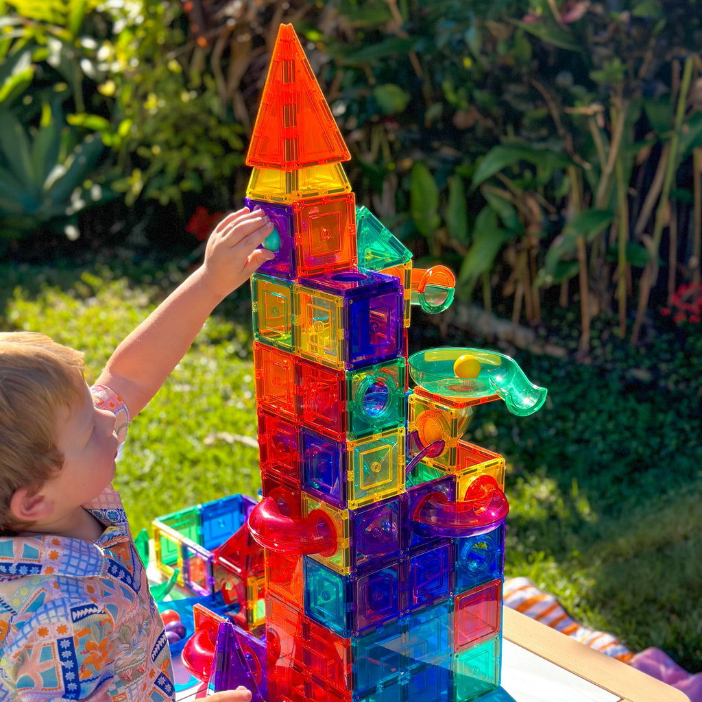 Child playing with Colourful magnetic ball run outside