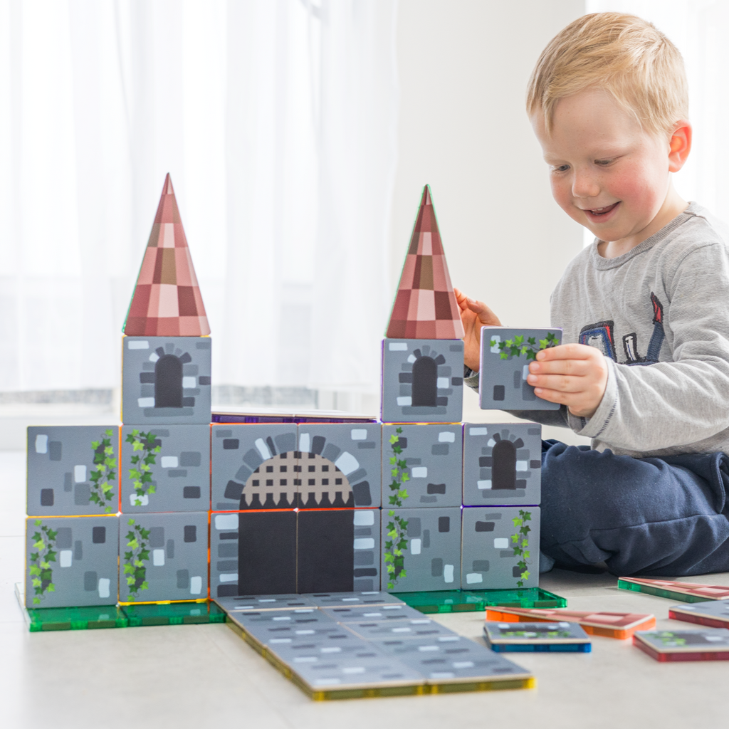 Child playing with Castle tile toppers 