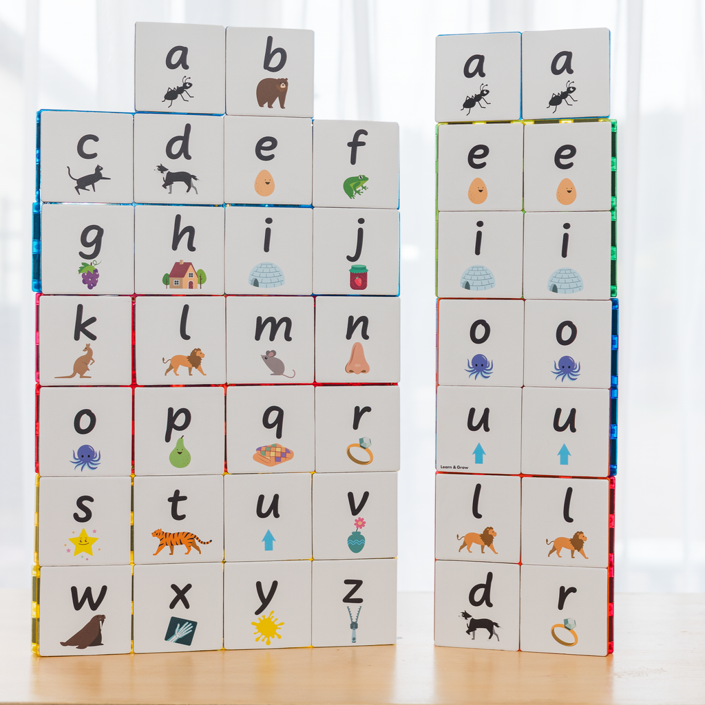 Magentic tiles on table with lowercase alphabet toppers on them