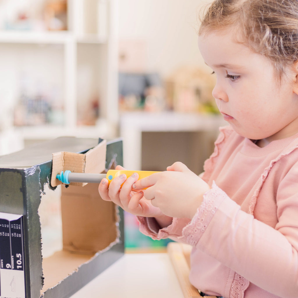 Child drilling using makedo discover kit