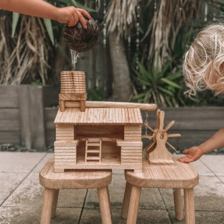 Explore-Nook-Eco-Hut-Water-Wheel played with by 2 children